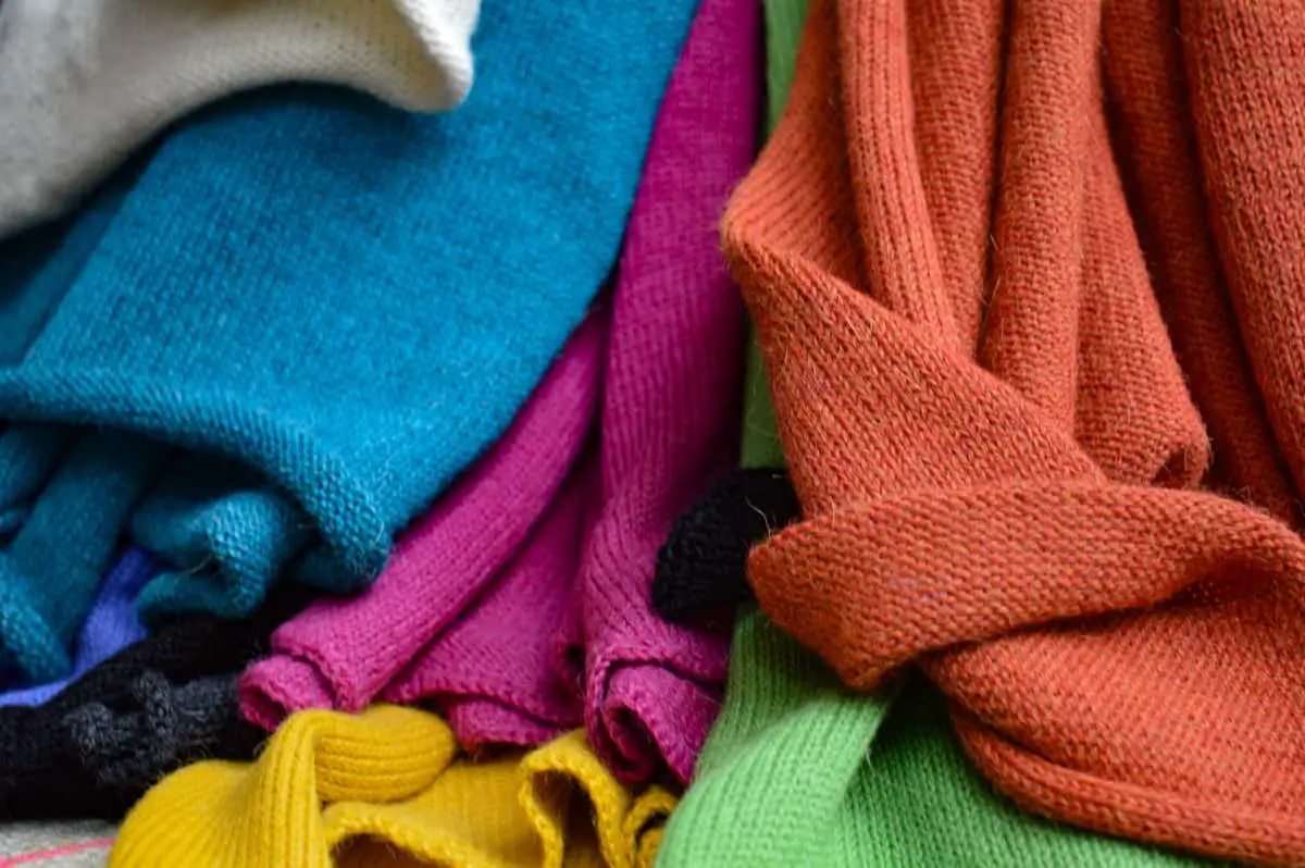 Colorful scarves of 100% alpaca wool. Knitted and shown with label. Blue, pink, green, orang, grey and yellow.