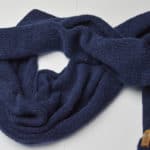 Tightly Knitted Scarf of soft baby alpaca and merino wool. TIght stitch with crocheted border and vegan label. Navy blue color, spread out.