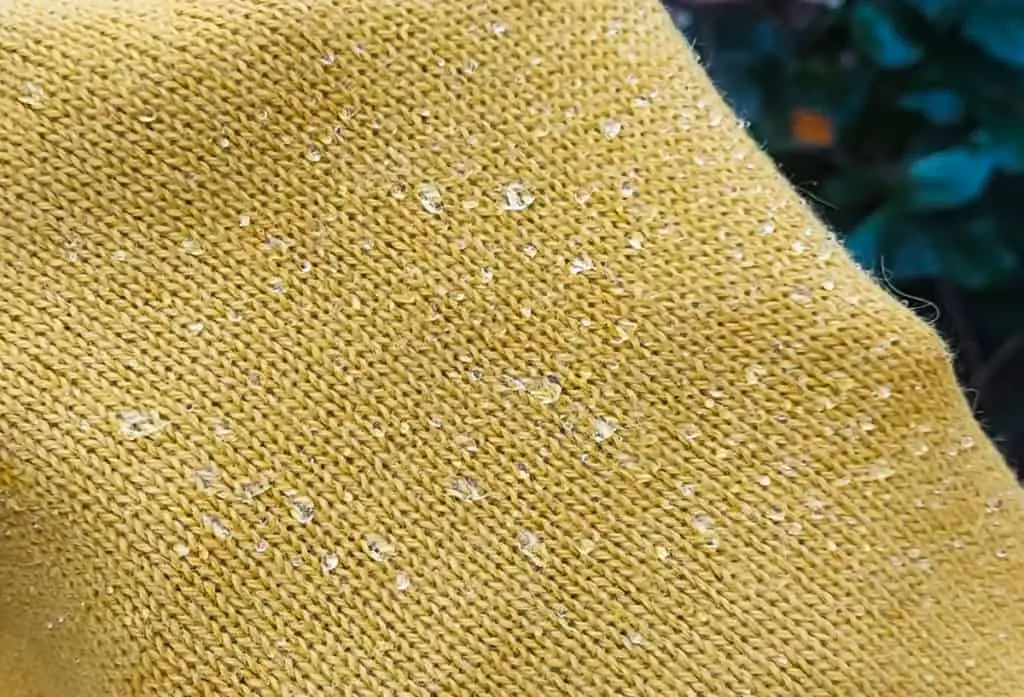 Water drops on an alpaca woolen scarf.