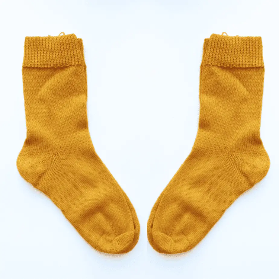 Pair of Yellow knitted socks, made with 100% alpaca wool. 